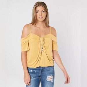 Buckle gimmicks off the shoulder top